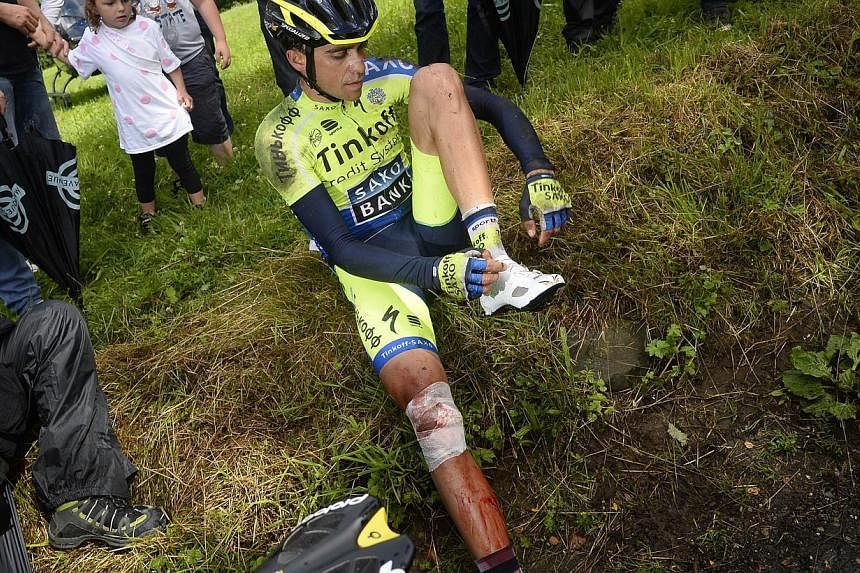 Spain's Alberto Contador sits after a fall during the 161.50 km tenth stage of the 101st edition of the Tour de France cycling race on July 14, 2014 between Mulhouse and La Planche des Belles Filles ski resort, eastern France.&nbsp;Alberto Contador h