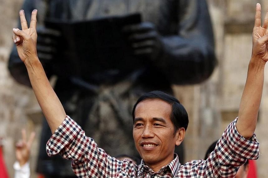Indonesian presidential candidate Joko "Jokowi" Widodo gestures during a rally in Proklamasi Monument Park in Jakarta on July 9, 2014.&nbsp;Jakarta's populist governor looks set to become Indonesia's next president, according to a private tally of 80