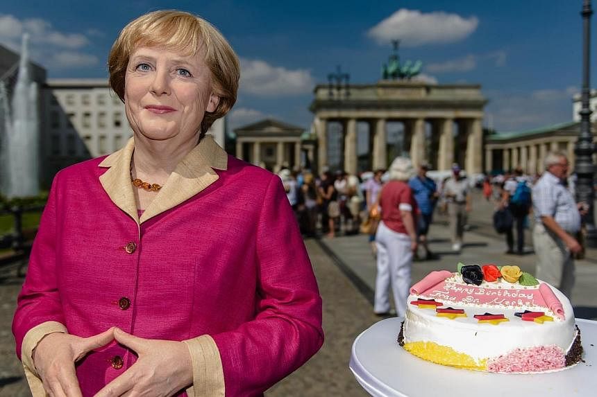 A wax likeness of German Chancellor Angela Merkel is pictured in front of the Brandenburg Gate in Berlin on July 16, 2014, on the occassion of Merkel's 60th birthday on July 17.&nbsp;Dr Angela Merkel, it seems, has had her fill of parties for now. --