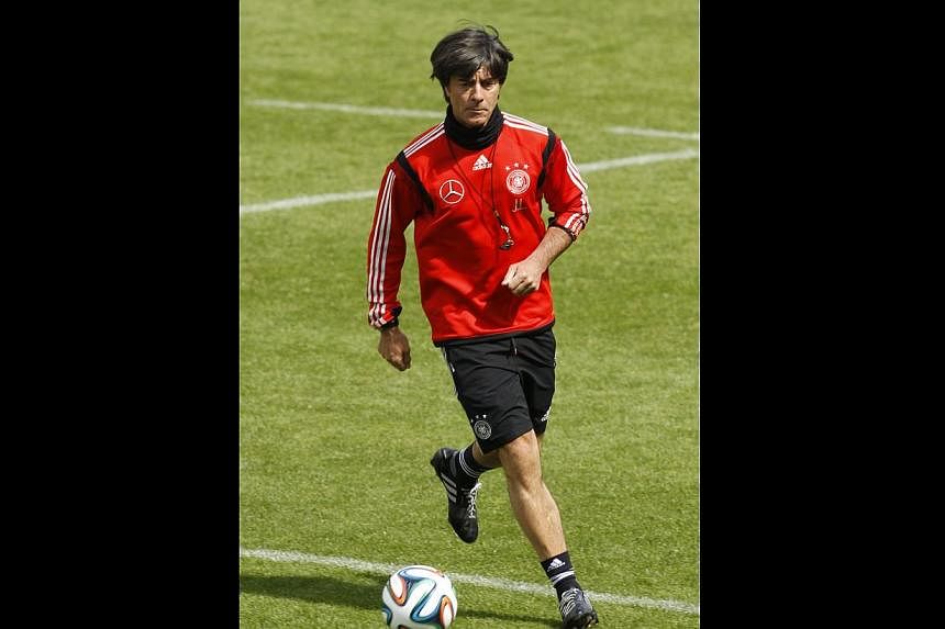 Germany's national soccer coach Joachim Loew kicks a ball during a training session in St. Martin, northern Italy, May 30, 2014. -- PHOTO: REUTERS
