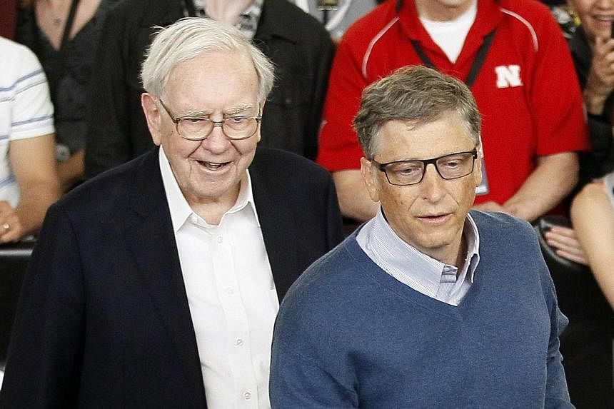 Berkshire Hathaway CEO Warren Buffett (left) and friend Bill Gates, founder of Microsoft, play table tennis at a Berkshire sponsored reception in Omaha, Nebraska on May 4, 2014 as part of the company annual meeting weekend.&nbsp;Warren Buffett this w
