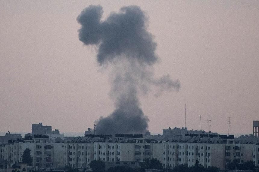 A picture taken from the southern Israeli city of Sderot shows smoke billowing from the Gaza Strip following an Israeli air strike on July 15, 2014.&nbsp;&nbsp;Israeli warplanes bombed the house of senior Hamas leader Mahmoud al-Zahar on Wednesday, s
