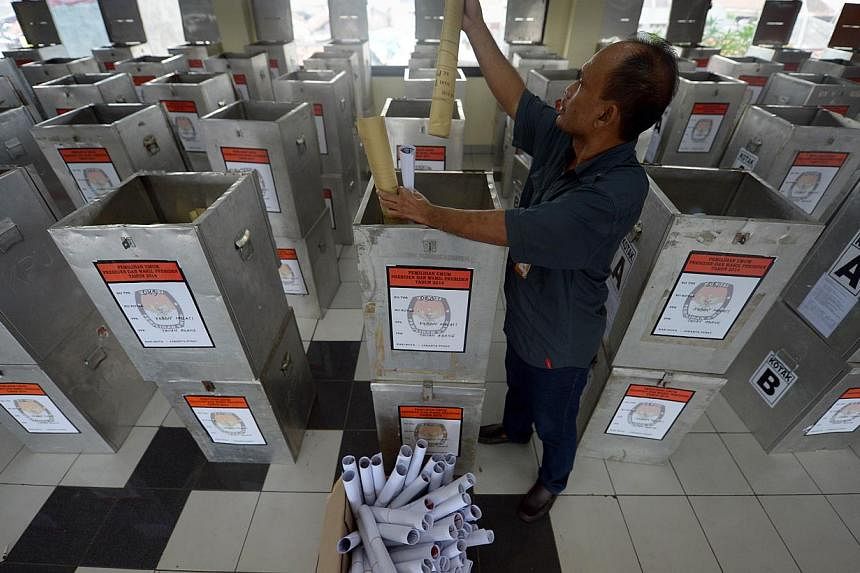 An Indonesian official checking election materials at a local election office in Jakarta on July 7, 2014. Indonesians vote on July 9, in the country's most pivotal presidential election since the downfall of dictator Suharto, with Jakarta governor Jo
