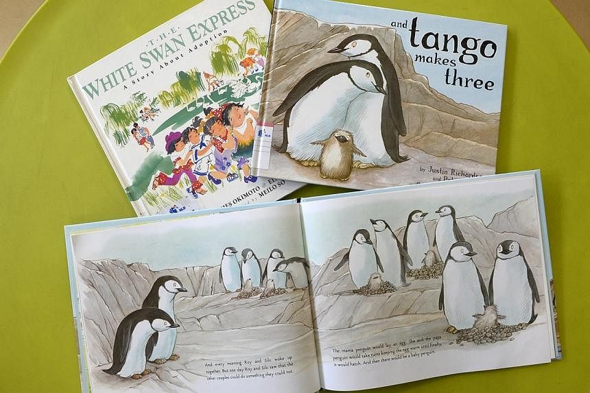 Two of the three children's titles - And Tango Makes Three (bottom and right) and The White Swan Express: A Story About Adoption (left), recently removed by the National Library Board (NLB).&nbsp;Three judges - T. Sasitharan, Romen Bose and Robin Hem