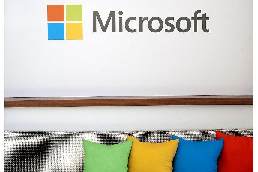 The Microsoft logo seen before the start of a media event in San Francisco, California on March 27, 2014.&nbsp;Microsoft said on Thursday, July 17, 2014, it would slash 18,000 jobs from its global workforce over the next year, the majority from the i
