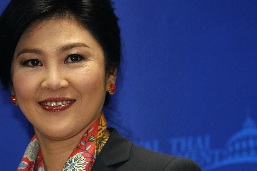 Thailand's Prime Minister Yingluck Shinawatra smiles as she arrives to address reporters in Bangkok on May 7, 2014.&nbsp;Thailand's junta has given permission to ousted former prime minister Yingluck Shinawatra to leave the country for the first time