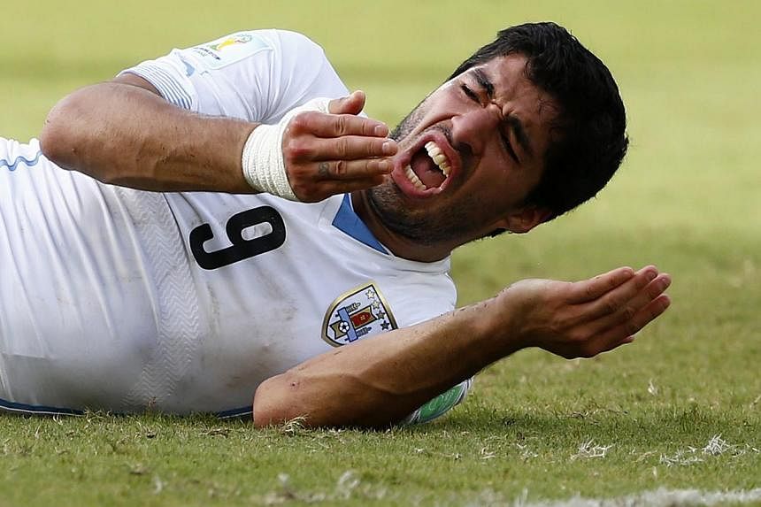 Uruguay's Luis Suarez reacts after clashing with Italy's Giorgio Chiellini during their 2014 World Cup Group D soccer match at the Dunas arena in Natal on June 24, 2014. -- PHOTO: REUTERS