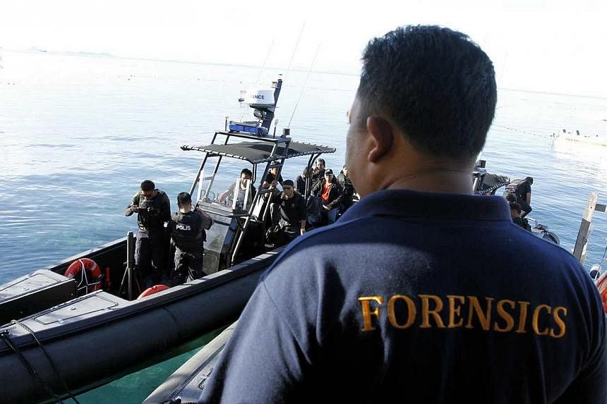 The police forensic team at the crime scene on Mabul island in Sabah, Malaysia, where a shootout had occurred at Mabul Water Bungalows Resort on 12 July 2014. -- PHOTO: THE STAR PUBLICATION
