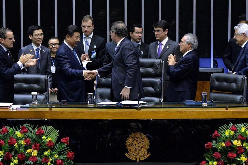 Chinese President Xi Jinping (third from left) is greeted at the Congress in Brasilia, on July 16, 2014. -- PHOTO: AFP