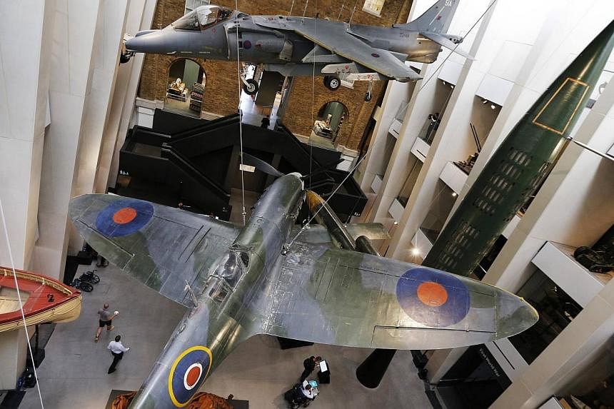 Members of the media and museum staff walk through the refurbished central atrium of the Imperial War Museum during a media preview, in central London on July 16, 2014. -- PHOTO: REUTERS&nbsp;