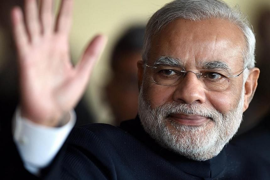 The United States said Wednesday that top Cabinet members will visit India in coming weeks to break the ice with Prime Minister Narendra Modi (above) who was once shunned by Washington. -- PHOTO: AFP