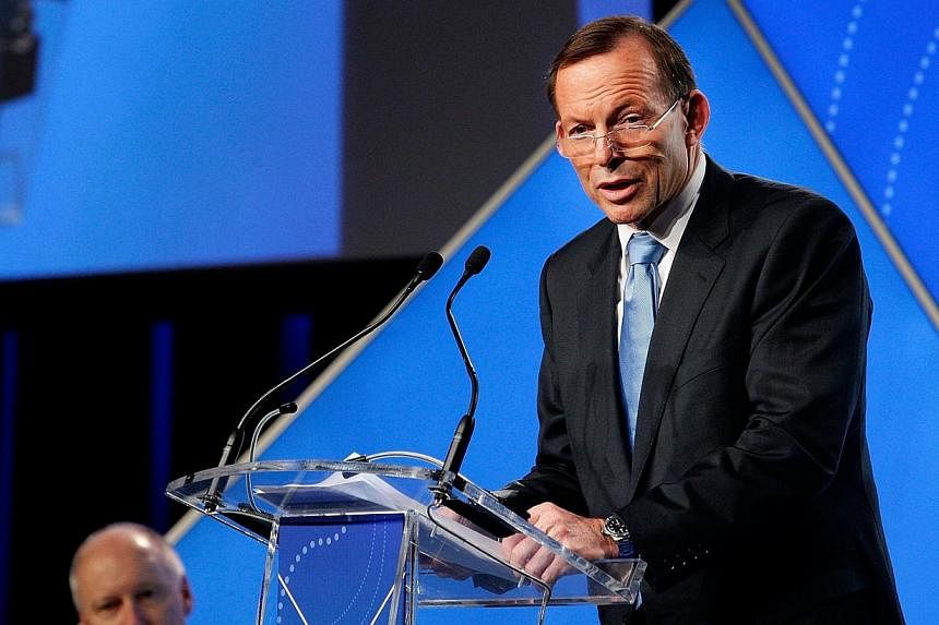 Australian Prime Minister Tony Abbott delivers his keynote speech during the B20 Summit in Sydney on July 17, 2014. Over 350 business leaders have gathered in Sydney for the 2014 B20 Summit to discuss and determine policy recommendations ahead of the