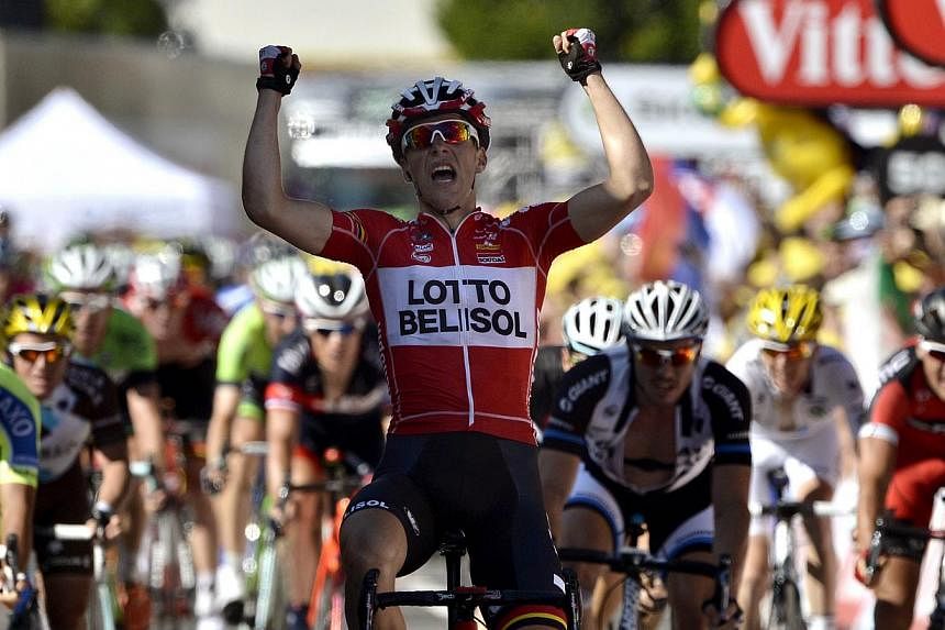 France's Tony Gallopin celebrates as he crosses the finish line at the end of the 187.5 km eleventh stage of the 101st edition of the Tour de France cycling race between Besancon and Oyonnax, eastern France on July 16, 2014. -- PHOTO: AFP