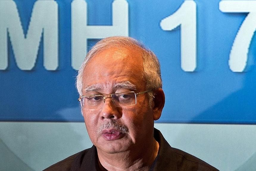 Malaysia's Prime Minister Najib Razak addresses a press conference at a hotel in Sepang, ouside Kuala Lumpur, on July 18, 2014, after Malaysia Airlines flight MH17 carrying 298 people from Amsterdam to Kuala Lumpur crashed in eastern Ukraine.&nbsp;Ma