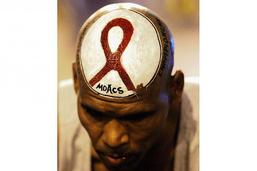 A 2006 file picture shows a participant with an Aids awareness message painted on his head getting ready to participate in the Standard Chartered Mumbai Marathon. HIV-positive people in the world's rich countries now live nearly as long as those who 