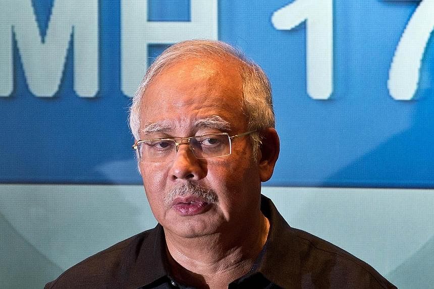 Malaysia's Prime Minister Najib Razak addresses a press conference at a hotel in Sepang, ouside Kuala Lumpur on July 18, 2014, after Malaysia Airlines flight MH17 carrying 298 people from Amsterdam to Kuala Lumpur crashed in eastern Ukraine. -- PHOTO