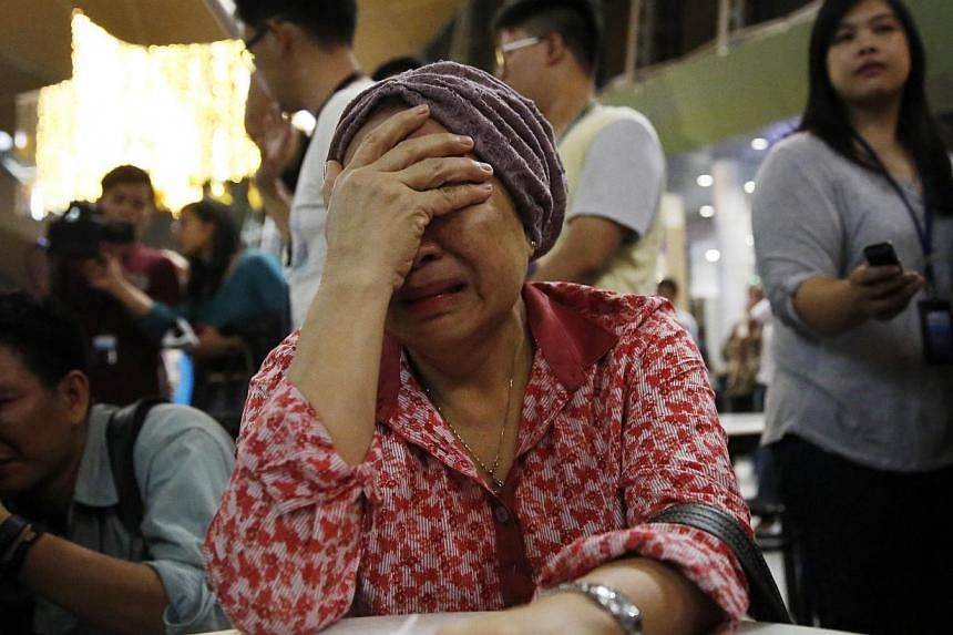 A woman, who said she believed her sister was on Malaysia Airlines flight MH17, cries as she waits for more information about the crashed plane at Kuala Lumpur International Airport in Sepang July 18, 2014. -- PHOTO: REUTERS