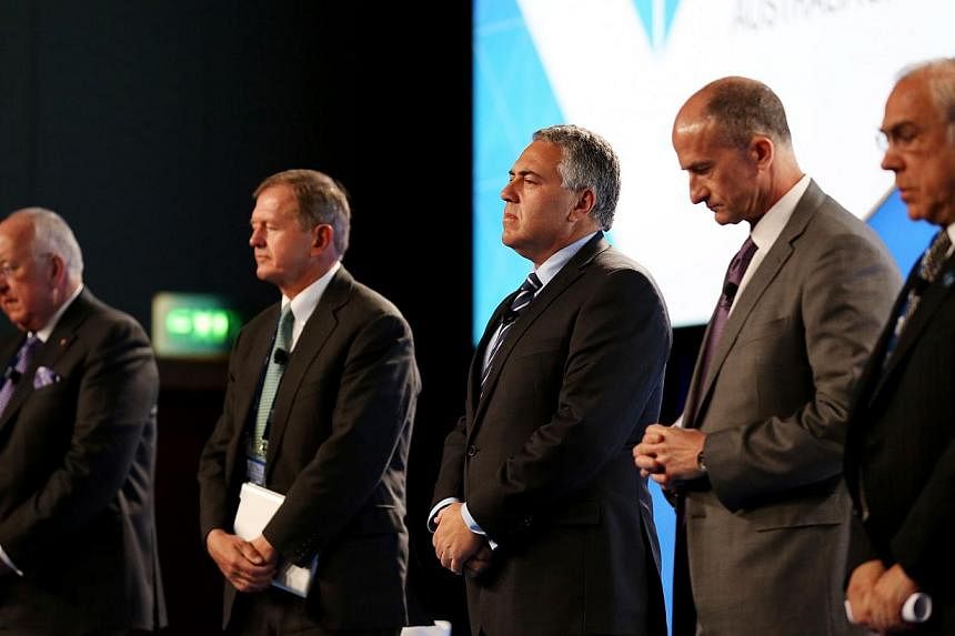(From left) Rio Tinto CEO Sam Walsh, SEB Chairman Marcus Wallenberg, Treasurer of Australia Joe Hockey, GE Global Growth and Operations CEO John Rice and OECD Secretary-General Angel Gurria hold a minute silence for the victims of Malaysia Airlines f