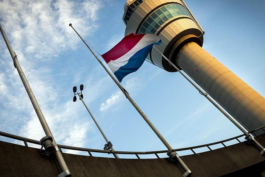 A Dutch flag is flown at half-mast at the Schiphol Airport near Amsterdam, on July 18, 2014.&nbsp;Interpol on Friday said it will send a team in the next 48 hours to help identify victims killed by the Malaysia Airlines flight MH17 crash in east Ukra