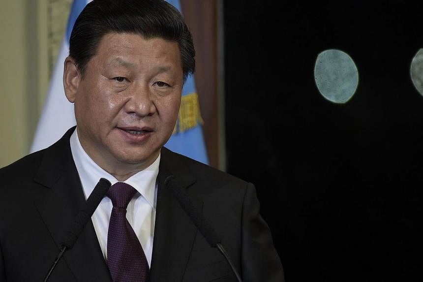 China's President Xi Jinping at a press conference next to Argentine President Cristina Fernandez de Kirchner (out of frame) after a meeting in Buenos Aires on July 18, 2014. He called on Friday for a "fair and objective" investigation into the crash