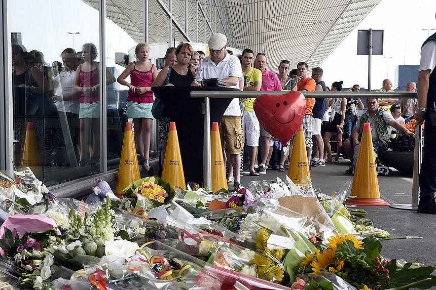 People sign a condolence register in front of Schiphol airport on July 19, 2014, two days after Malaysia Airlines flight MH17 carrying 298 people from Amsterdam to Kuala Lumpur crashed in eastern Ukraine.&nbsp;Relatives of the 192 Dutch victims of Ma