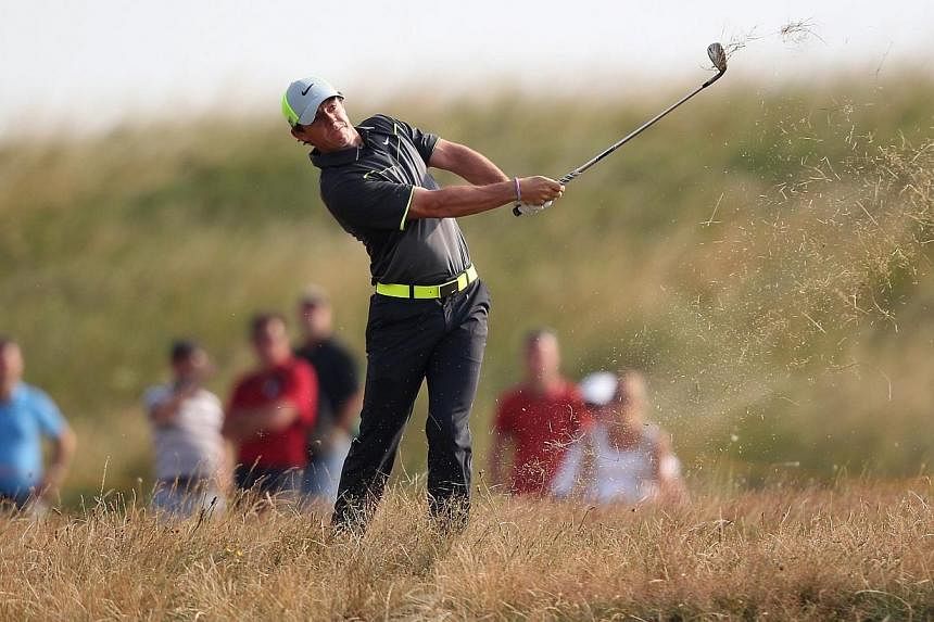 Northern Ireland's Rory McIlroy plays from the rough on the 12th hole during his second round 66, on day two of the 2014 British Open Golf Championship at Royal Liverpool Golf Course in Hoylake, north-west England on July 18, 2014.&nbsp;-- PHOTO: AFP