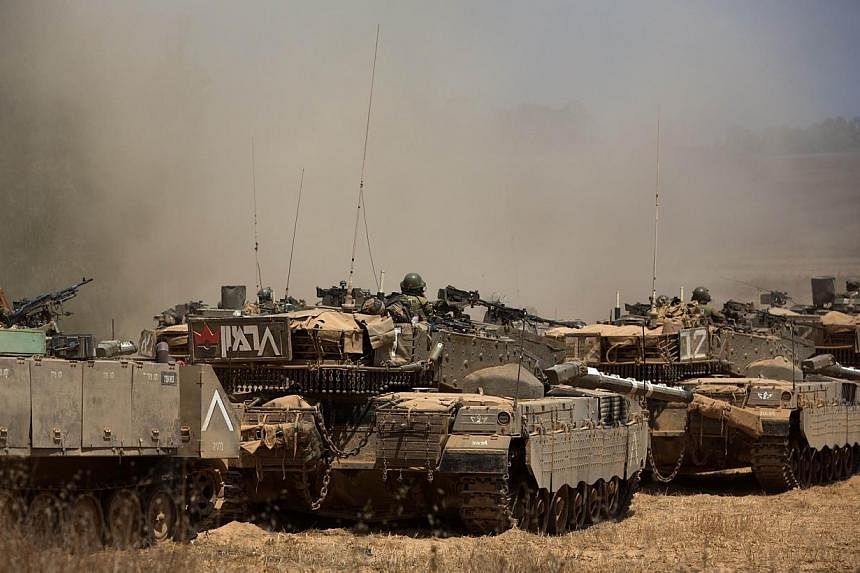 Israeli Merkava tanks roll towards the Israeli-Gaza border in an army deployment area on July 19, 2014.&nbsp;Nine Palestinians were killed in Israeli bombing across the Gaza on Saturday, July 19, 2014, afternoon, raising the toll in 12 days of violen