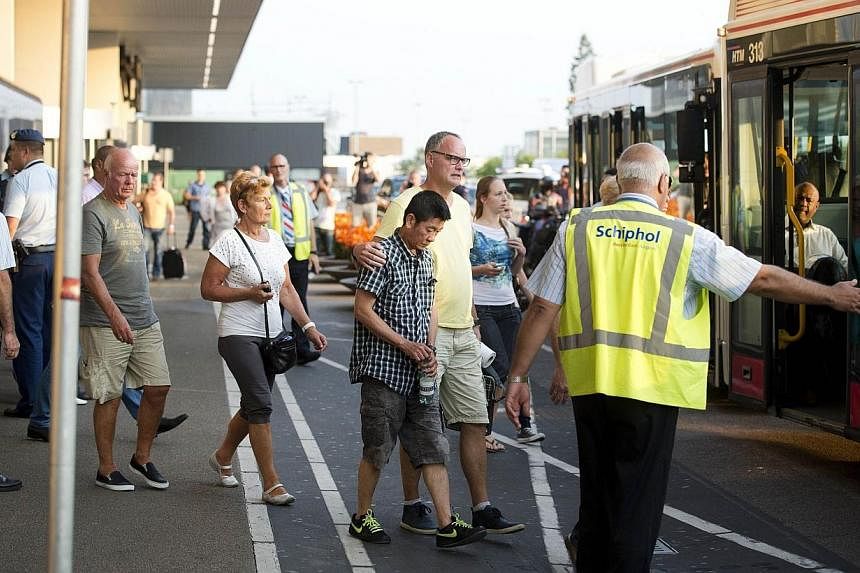 Relatives of passengers of Malaysia Airlines flight MH17 get onto a bus at Schiphol Airport near Amsterdam, the Netherlands, on July 17, 2014, headed for an unkown destination after they received additional information about the Malaysia Airlines pla