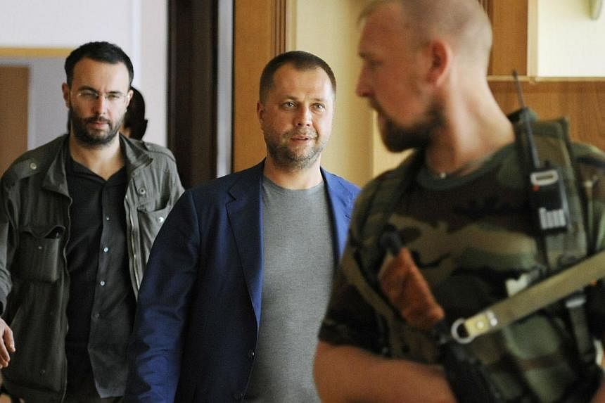 Self-proclaimed Prime Minister of the pro-Russian separatist "Donetsk People's Republic" Alexander Borodai walks to his press-conference Donetsk on July 18, 2014. -- PHOTO: AFP