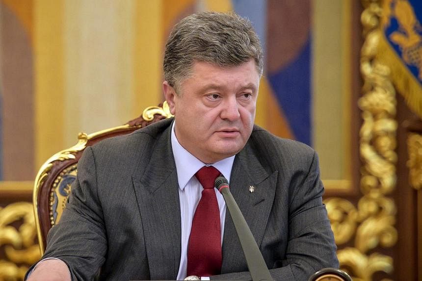 Ukrainian President Petro Poroshenko chairs a meeting in Kiev on July 17, 2014. Mr Poroshenko told Dutch Foreign Minister Frans Timmermans that he would not tolerate interference in the work of international monitors and other experts investigating t
