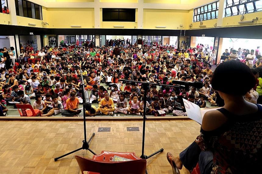 More than 200 children set a Singapore record at a mass reading session on Saturday, July 19, 2014, for the "most number of children reading with an adult". -- ST PHOTO:&nbsp;CHEW SENG KIM