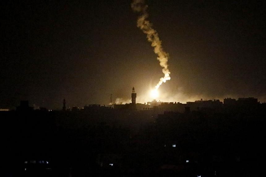 A flare sent by Israeli army illuminates the eastern part of Gaza City on July 18, 2014. Fifty-five Gazans were killed on Friday as Israel pressed a major ground offensive in the coastal enclave, raising the overall Palestinian death toll since July 