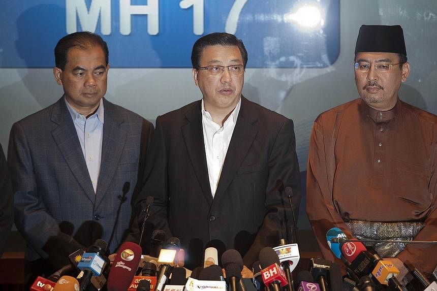 Malaysia's Transport Minister Liow Tiong Lai (centre) addresses the media at a hotel near the Kuala Lumpur International Airport in Sepang on July 18, 2014. Mr Liow will lead a team of medical staff and investigators to the crash site of Malaysia Air