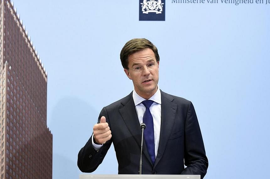 Dutch Prime Minister Mark Rutte speaks during a press conference at the Ministry of Safety and Justice in The Hague, the Netherlands, on July 18, 2014, regarding Malaysia Airlines flight MH17 that crashed on July 17 in eastern Ukraine. -- PHOTO: AFP