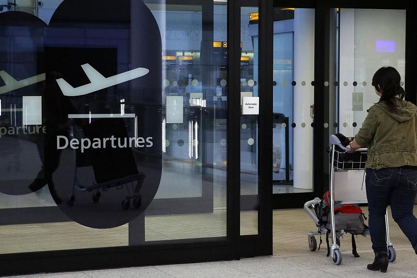 A passenger enters departures in Terminal 2 at Heathrow Airport in London on July 3, 2014. -- PHOTO: REUTERS