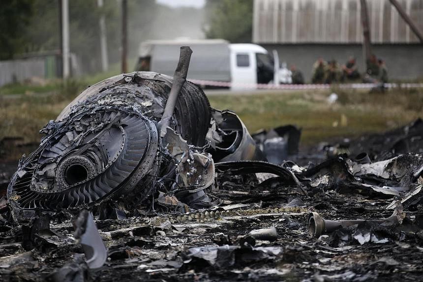 Debris is pictured at the site of Malaysia Airlines Boeing 777 plane crash, near the village of Grabovo in the Donetsk region July 18, 2014. -- PHOTO: REUTERS