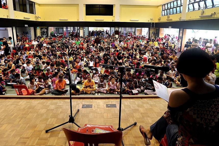 More than 200 children at the Hong Kah North Reading Carnival read stories from the Mustard Seed series by award-winning local writer Emily Lim (with her back to the camera), setting a Singapore record.