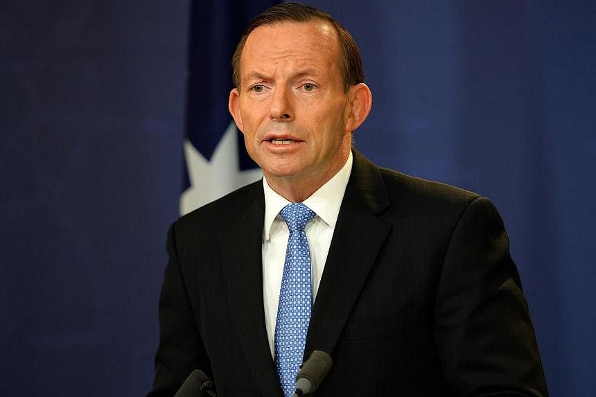 Australian Prime Minister Tony Abbott speaks at a press conference in Sydney on July 19, 2014. -- PHOTO: AFP