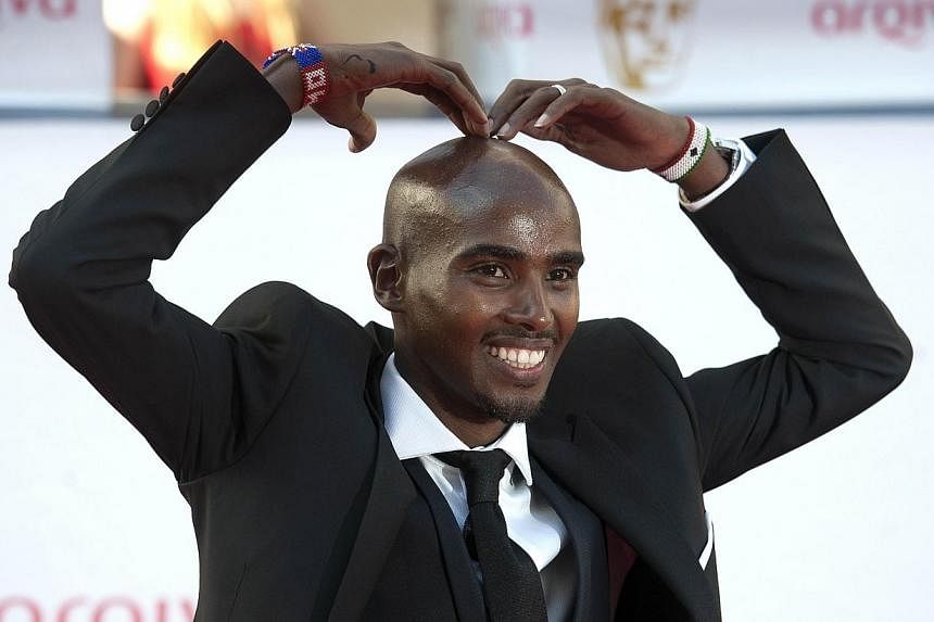 British athlete Mo Farah poses for pictures on the red carpet upon arrival for the BAFTA TV awards in London on May 18, 2014.&nbsp;Olympic champions Usain Bolt, Mo Farah and Bradley Wiggins headline a host of star names hoping to bury injury problems