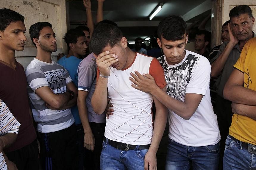 A relative of Palestinians, who medics said were killed overnight by Israeli shelling, grieve at their funeral in Khan Younis in the southern Gaza Strip on July 19, 2014.-- PHOTO: REUTERS