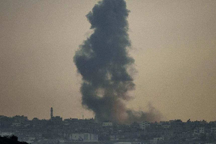 A picture taken on July 19, 2014 from the southern Israeli-Gaza border shows smoke billowing from buildings following an Israeli air strike on Gaza City.&nbsp;Israel's Government Press Office on Saturday warned foreign journalists it was not responsi