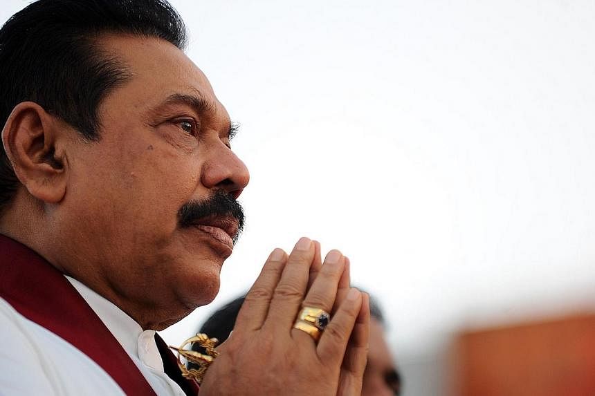 Sri Lanka President Mahinda Rajapakse prays during a religious ceremony at the 76 million dollar oil tank farm at the southern deep sea port of Hambantota on June 22, 2014.&nbsp;A Sri Lankan government crackdown this month on NGOs has sparked claims 