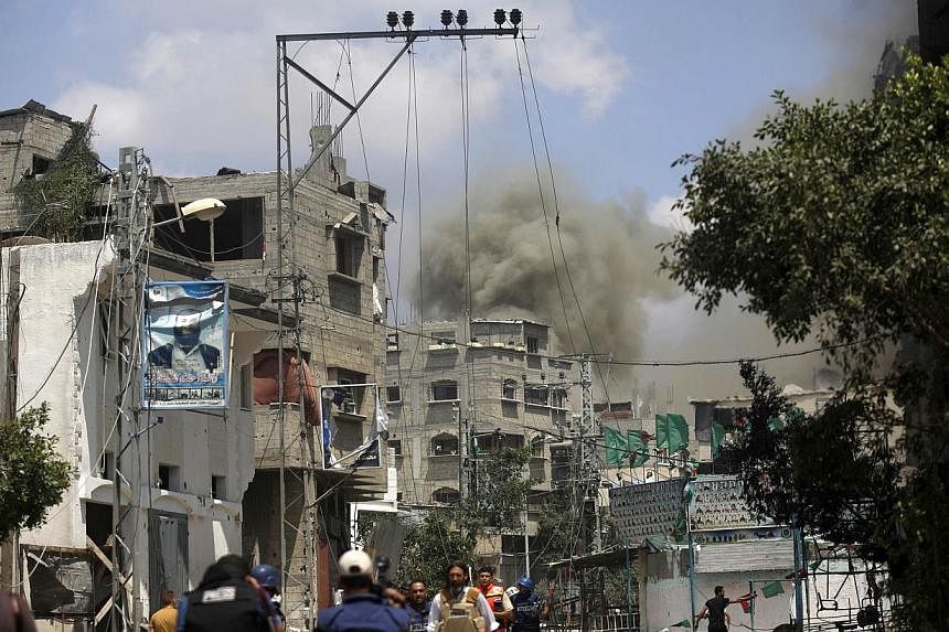 Smoke rises during the ongoing Israeli military offensive on the Shejaiya neighborhood between Gaza City and the Israeli border on July 20, 2014.&nbsp;More than 60 Palestinians were killed Sunday as Israeli forces pounded northern Gaza, sending thous