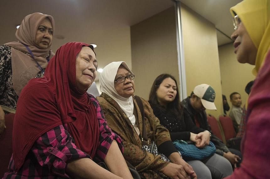 Relatives of a passenger who was on board Malaysia Airlines flight MH17 from Amsterdam to Kuala Lumpur meet with Malaysia's Woman, Family and Community development Minister Rohani Abdul Karim (right) at a hotel in Putrajaya on July 20, 2014.&nbsp;Fam