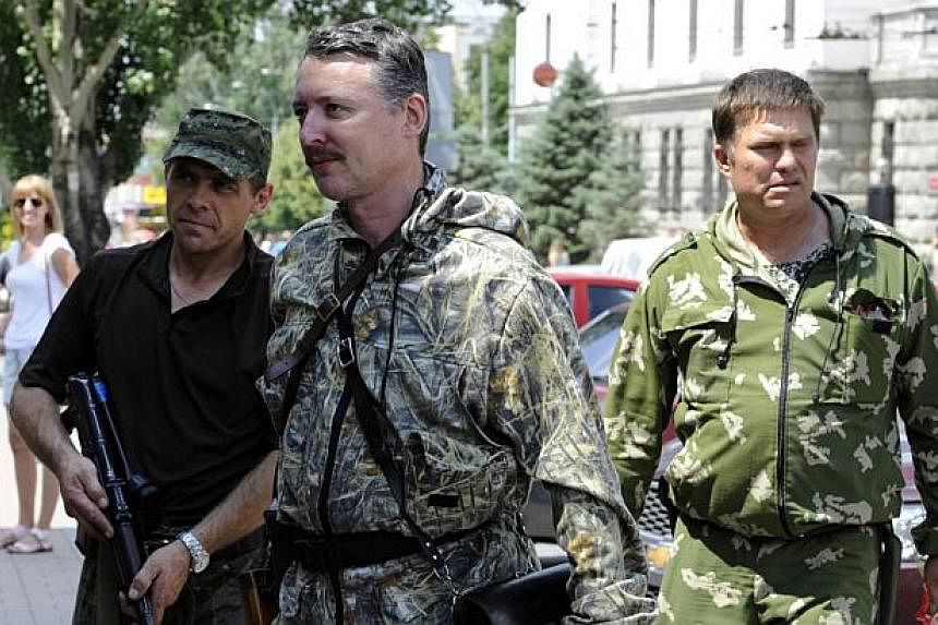 Commander and self-proclaimed minister of Defence of so the called "Donetsk People's Republic" Igor Girkin, aka Strelok (centre), walks with his bodyguards in the eastern Ukrainian city of Donetsk on July 11, 2014.&nbsp;Pro-Russian separatist leader 