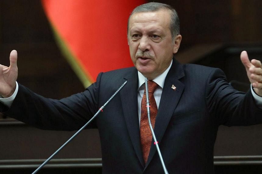 Turkish Prime Minister Recep Tayyip Erdogan addresses on July 15, 2014 deputies of his ruling Justice and Development Party (AKP) at the parliament in Ankara.&nbsp;Turkish Prime Minister Recep Tayyip Erdogan on Saturday launched a fresh virulent atta