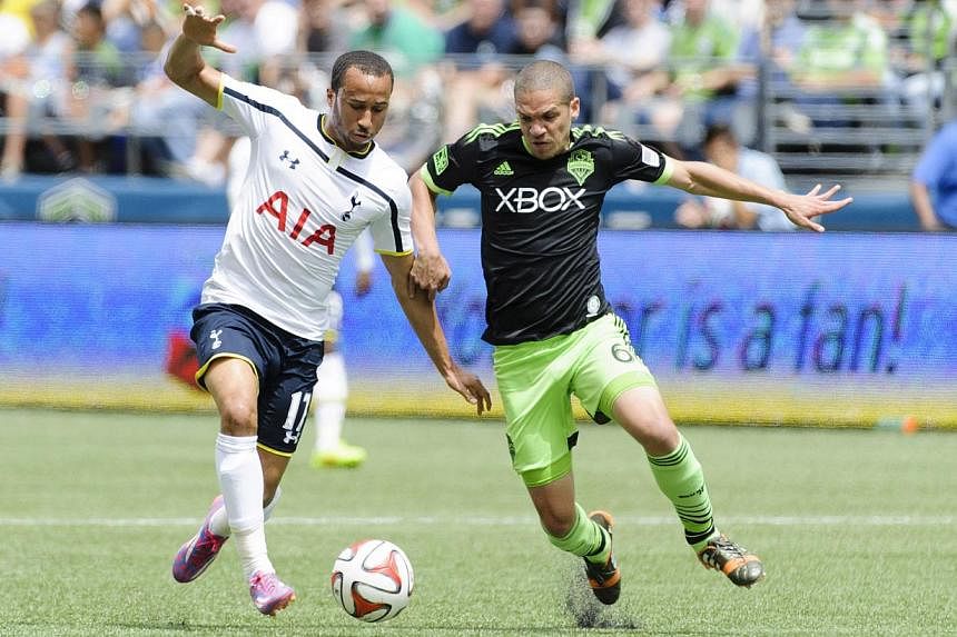 Tottenham Hotspur midfielder Andros Townsend (left) and Seattle Sounders FC midfielder Osvaldo Alonso fight for the ball during the first half at CenturyLink Field. -- PHOTO: REUTERS