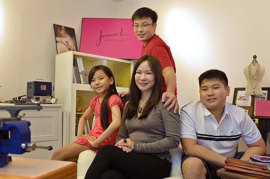 Ms Joanne Low with her children (from left) Kaitlyn, eight; Evan, 14; and Iain, 12. Ms Low left her job as a lawyer 12 years ago and now has her own jewellery business. -- ST PHOTO: CAROLINE CHIA