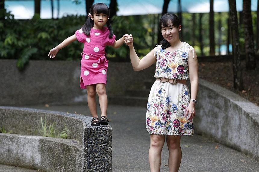 Ms Serene Lee, 34, with her daughter Chloe, four. A recent survey found that although staggered start and end times were the top-ranked benefit among working mums with young children, less than a quarter used the scheme.