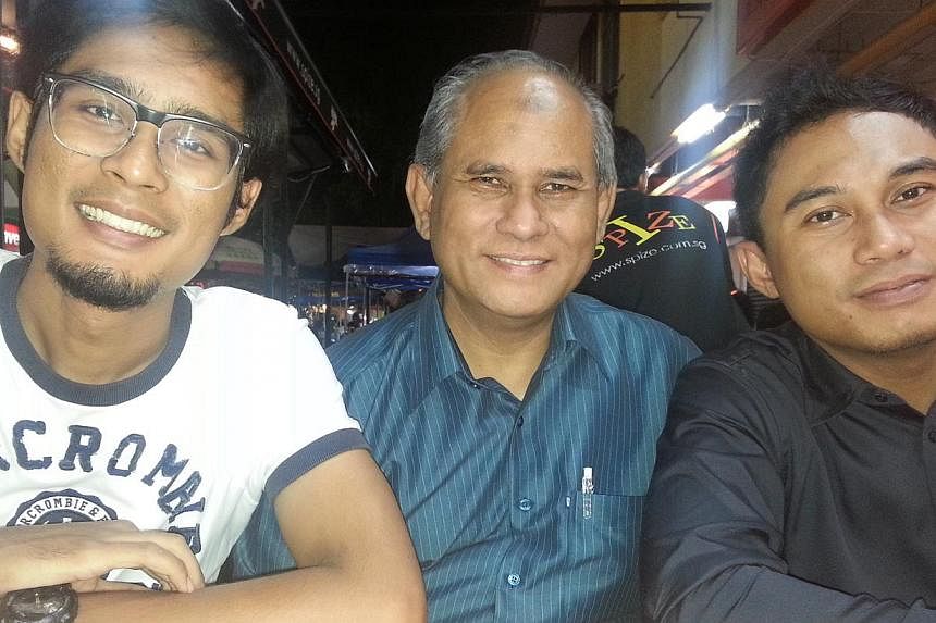 Mr Adnan Hajisirat with his sons Mohammad Firman (left) and Mohammad Fairuz. Mr Adnan and his wife are planning to move from Tampines to Bukit Panjang when Mr Firman gets a flat there. -- PHOTO: COURTESY OF ADNAN HAJISIRAT